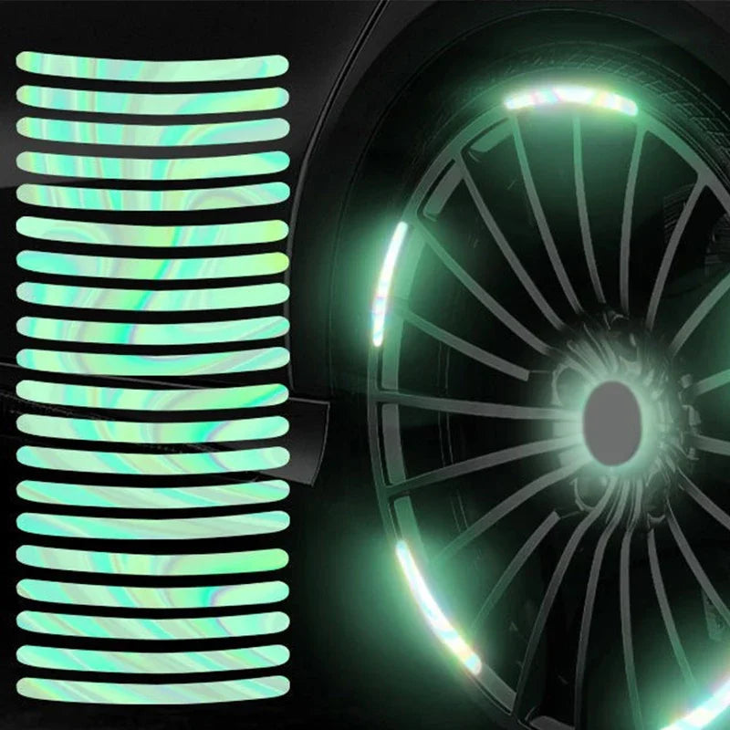 Close-up of reflective wheel rim strips installed on a dark surface.