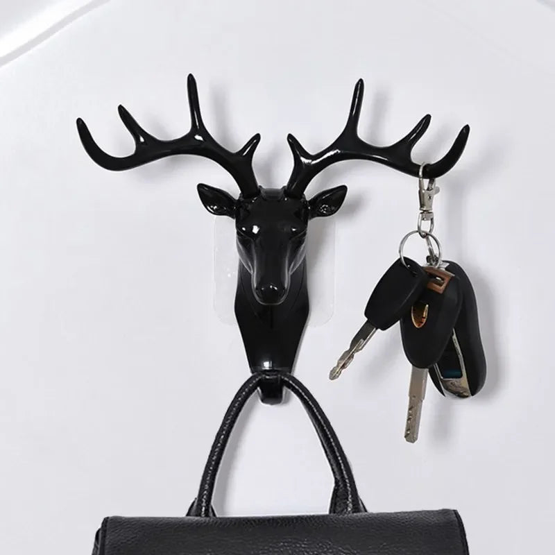 Black vintage deer head wall hook featuring antlers, used for hanging hats, scarves, and keys.