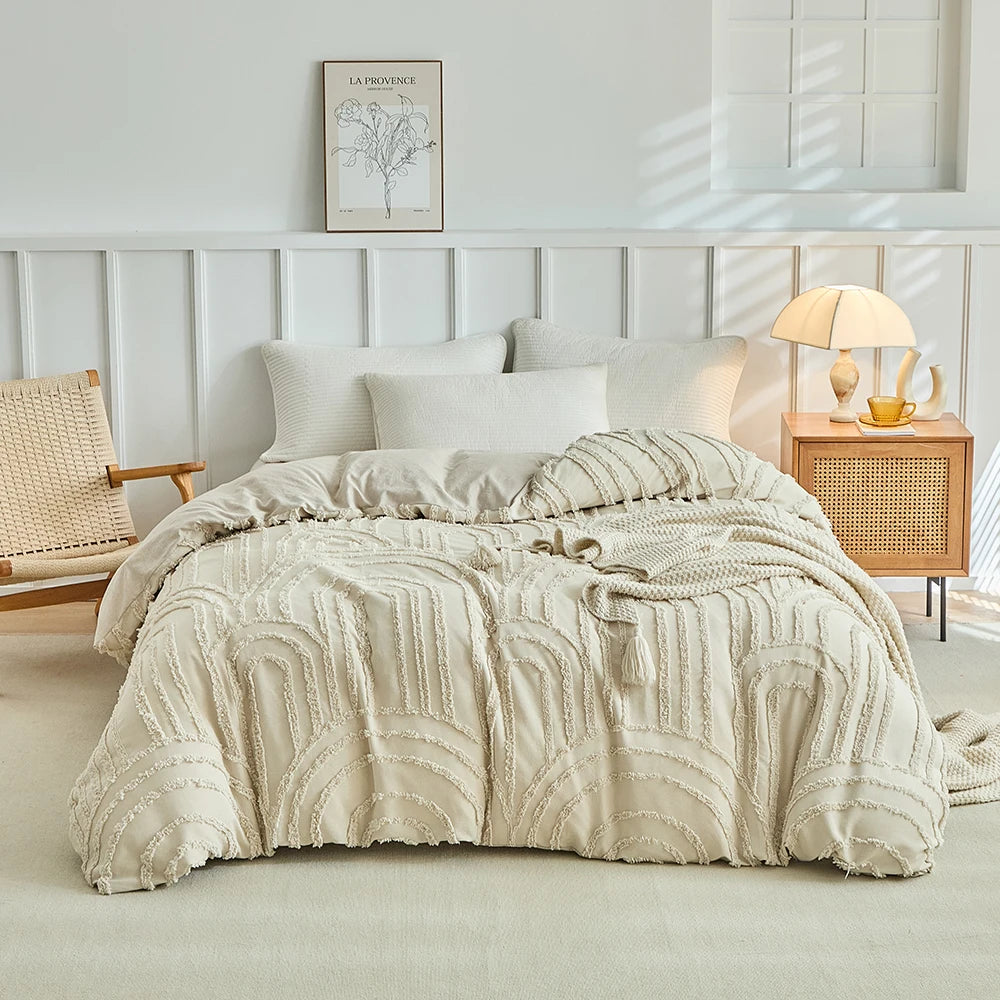Beige besticktes Blumen-Duvetcover-Set auf einem Bett mit weiß gerahmtem Kopfteil und natürlichem Licht.