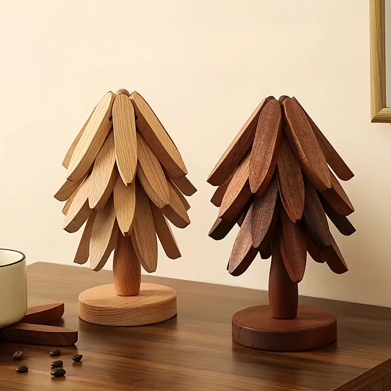 A set of wooden tree-shaped heat-resistant trivets displayed on a dark wooden surface.