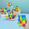 Colorful transformable fidget puzzle toys shaped like animals and geometric figures displayed on a light blue surface.