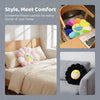 A cheerful sunflower plush cushion with a smiling face is shown in various home settings.