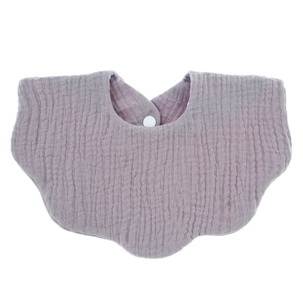 A soft lavender cotton baby bib in a bandana style with a rounded neckline.