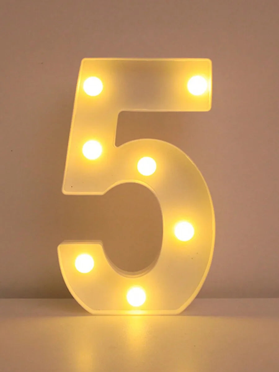 A glowing LED letter night light shaped like the number five, illuminating the letters with bright white lights.