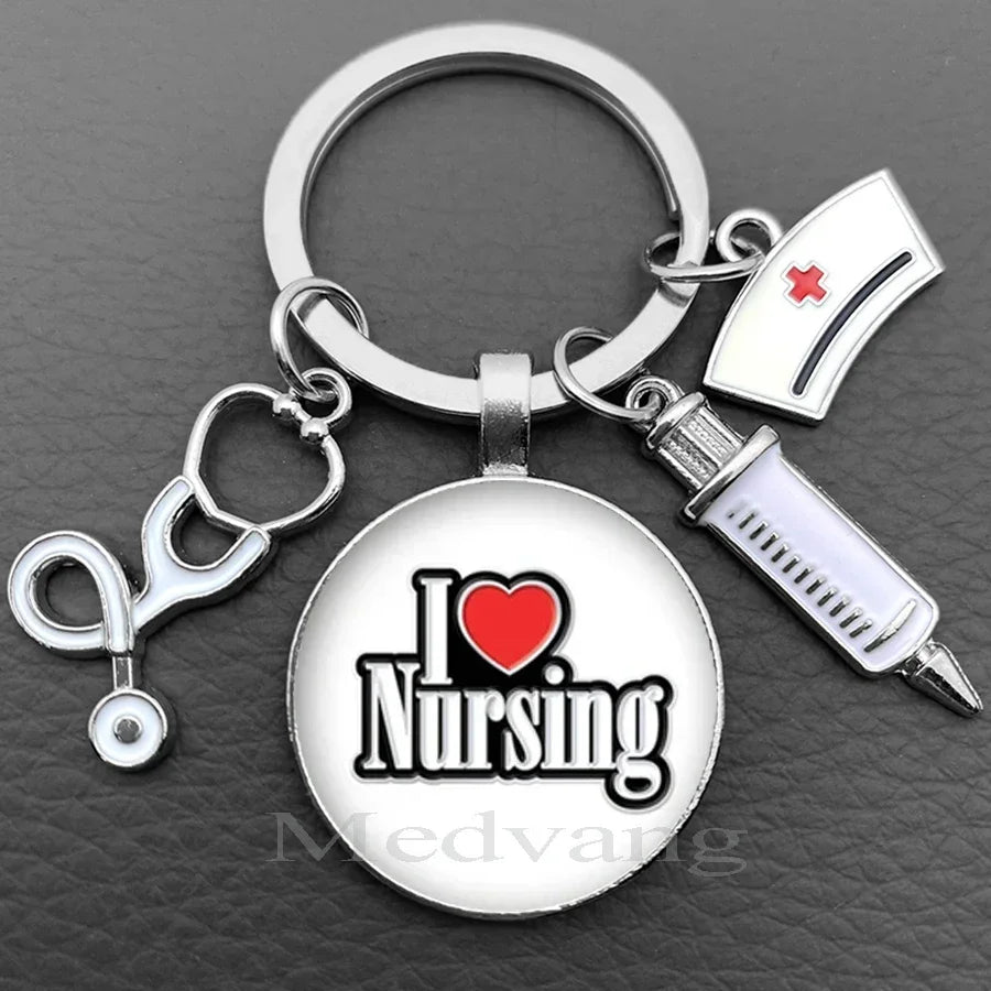 Silver keychain featuring a glass dome charm with the text I Love Nursing and a medical symbol.