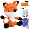 An orange and black fox crochet toy with accompanying yarn and a DIY guide.
