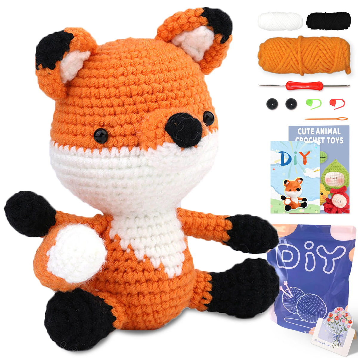 An orange and black fox crochet toy with accompanying yarn and a DIY guide.