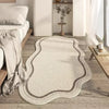 A beige irregular area rug with a plush texture is placed on a light wood floor next to a white wall and shelving.
