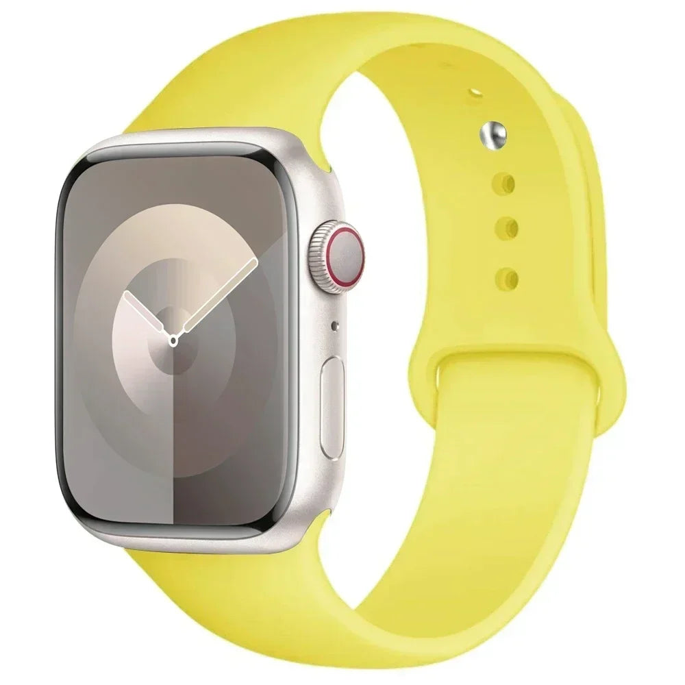 A yellow silicone sport band is shown next to an Apple Watch, highlighting the watch and strap.