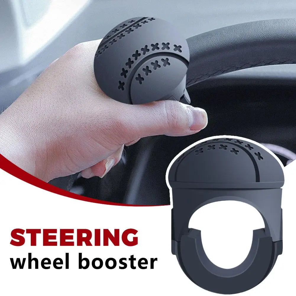 A hand is shown gripping a black steering wheel booster knob designed for one-hand control.