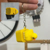 A yellow fidget keychain shaped like a duck with an electronic component hanging from a silver chain.