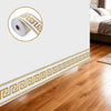 Roll of self-adhesive PVC foam wallpaper border trim with a gold and white Greek key pattern