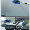 Extendable car windshield cleaner with a microfiber pad cleaning the glass.