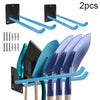 Two black wall-mounted racks with blue tool holders and several garden tools.