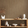 A display of ceramic and wooden decorative items against a vertical striped brown wall background.