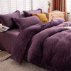 A purple velvet duvet cover with a zipper and a yellow accent pillow on a bed.