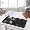 A black drawing sketch kit with graphite and charcoal pencils and a sketchbook is displayed on a white table.