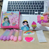 A DIY beaded pen craft kit featuring princess and rainbow designs, displayed next to a laptop.