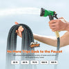 A hand sprays water from a green FlexiHose garden hose onto a surface.