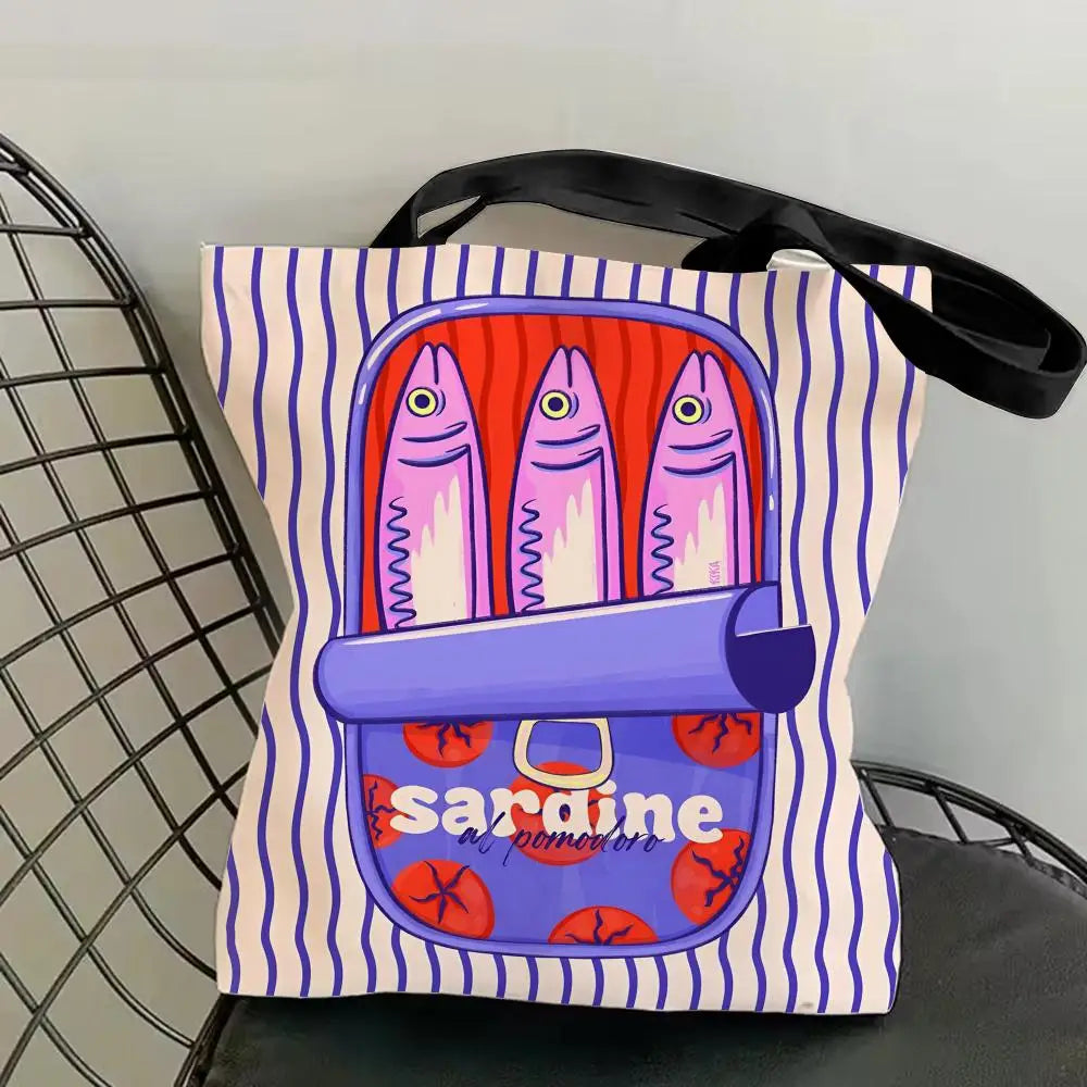 A canvas tote bag featuring a colorful print of sardines on a striped background.