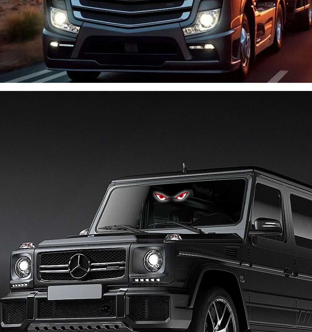 Close-up of a black Mercedes SUV with a custom demon eye LED window decal on the rear window.