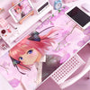 Anime character illustration on a pink mouse pad featuring pink hair and floral designs.