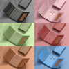 A collection of classic leather card holder wallets in various shades including black, pink, green, red, and brown.