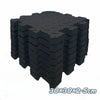 Eight interlocking foam play mats in black with a textured surface, shown from above.