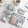 A collection of transparent mesh storage bags with zippers, including coin and card organizers, arranged on a white surface.