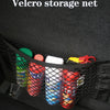 Velcro storage net filled with various colorful bottles and containers inside a black organizer pocket