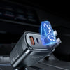 A close-up of a black car charger with a blue digital display showing voltage information.