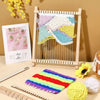 A wooden weaving loom kit with colorful yarn and a finished textile displayed on a light wooden surface.