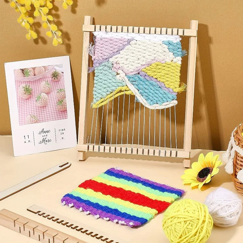 A wooden weaving loom kit with colorful yarn and a finished textile displayed on a light wooden surface.