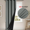 A dark gray blackout curtain is shown hanging in a window, demonstrating its full coverage and blackout capability.