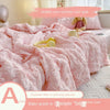 Pink bubble yarn summer cool quilt with a stuffed animal and a yellow earbud