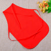 A bright red non-woven fabric craft apron is shown against a beige background with some yellow flowers.