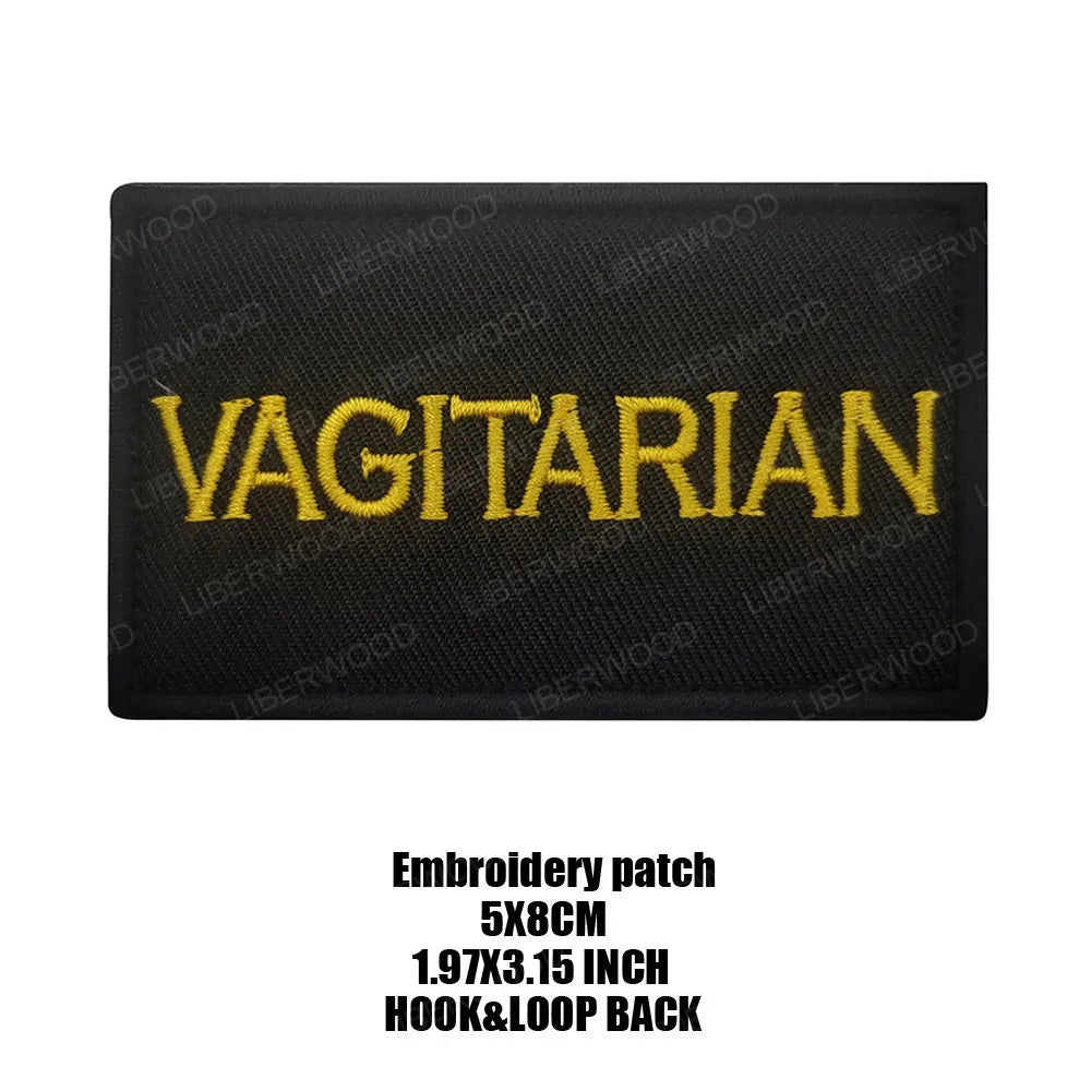 Black embroidered patch with the word VEGETARIAN in yellow text