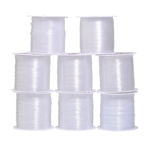 A collection of white nylon beading cord spools in various sizes and rolls.