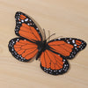 A set of ten realistic monarch butterfly magnets and adhesive decor featuring orange and black wings