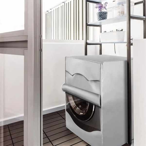 A silver waterproof washing machine cover with a roll edge design is shown inside a modern bathroom or laundry area.