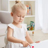 A young girl is painting on a white surface using a portable watercolor painting book and brush for children's graffiti.