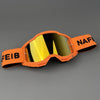 Orange professional MX off-road goggles with a yellow lens and black text on the frame