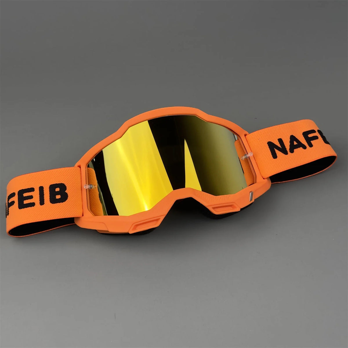 Orange professional MX off-road goggles with a yellow lens and black text on the frame