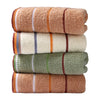 A stack of four bath towels in various shades of brown, beige, and green with striped accents.