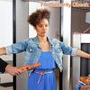 A woman wearing a blue dress and denim jacket is being scanned with a handheld metal detector for security check.