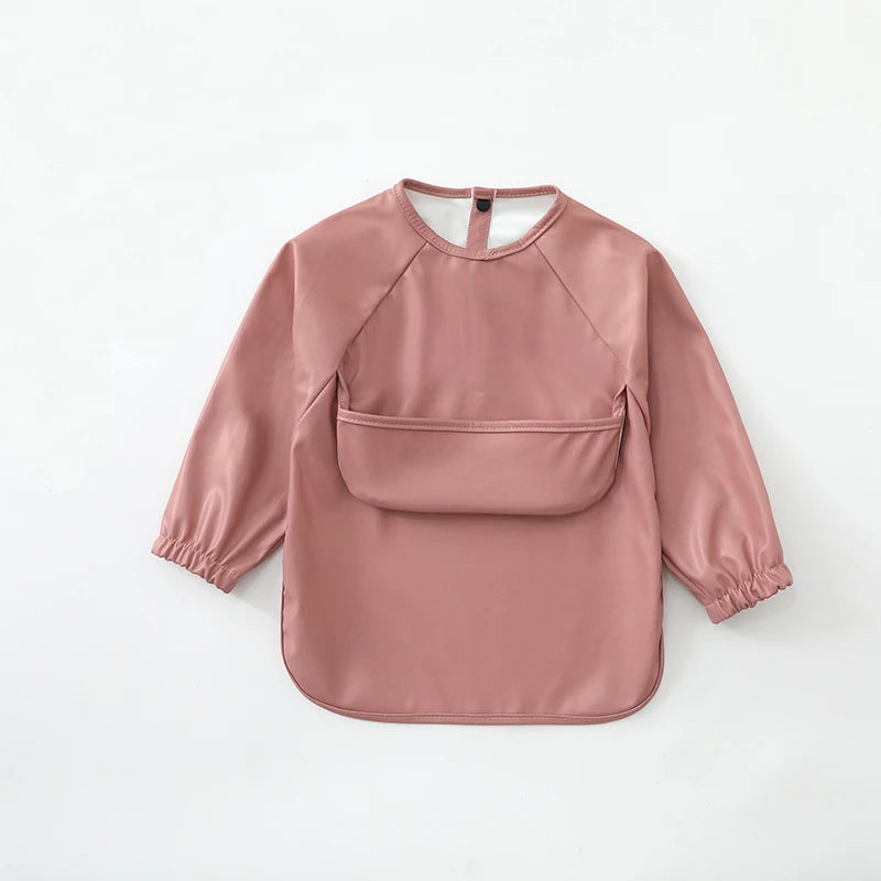 A soft dusty rose waterproof long-sleeve art smock for toddlers.