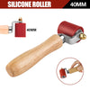 A wooden handle silicone roller tool with a red 40mm roller and metal fittings for welding.