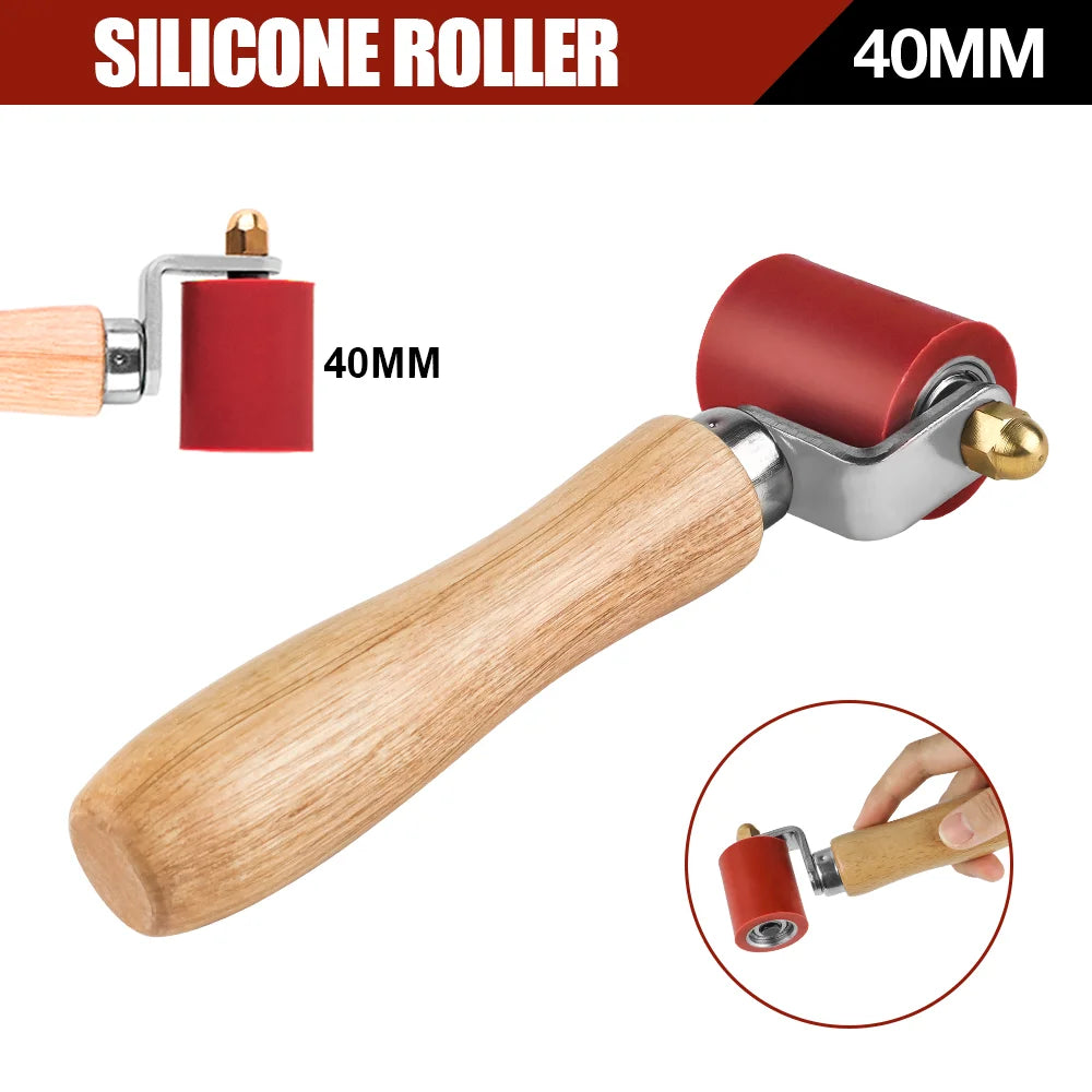 A wooden handle silicone roller tool with a red 40mm roller and metal fittings for welding.