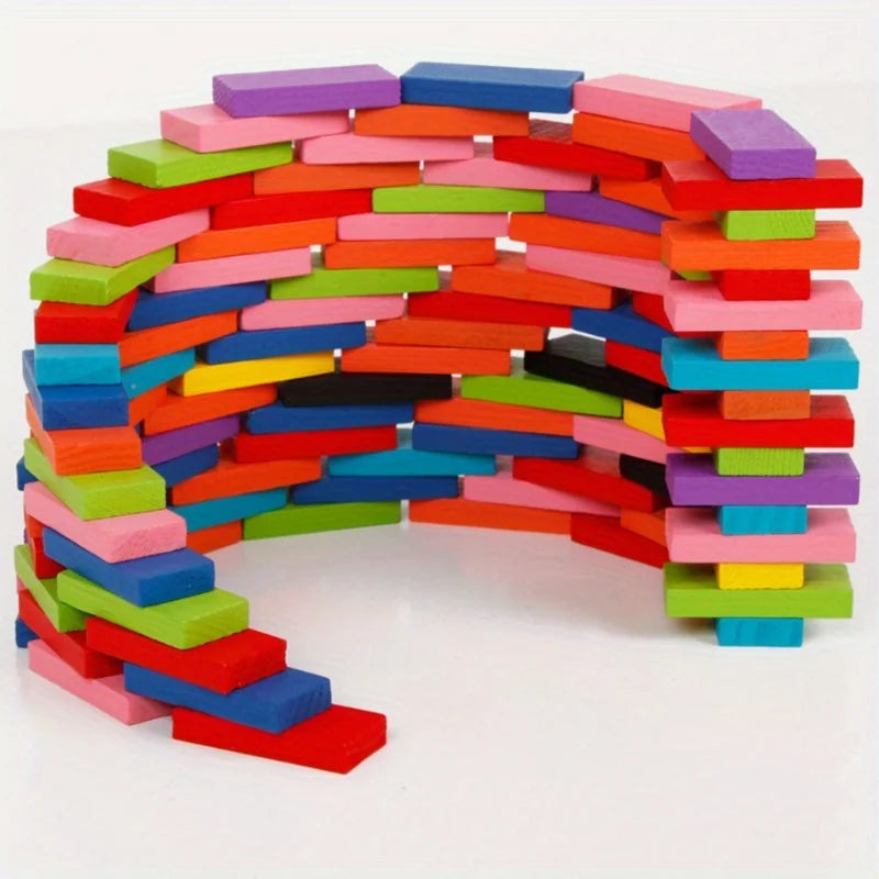 A colorful, curved structure built from 120 wooden domino blocks in various shades of pink, red, blue, green, and purple.