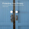 Close-up of a blue wooden door featuring a stainless steel flip barn door lock with keys and security features.